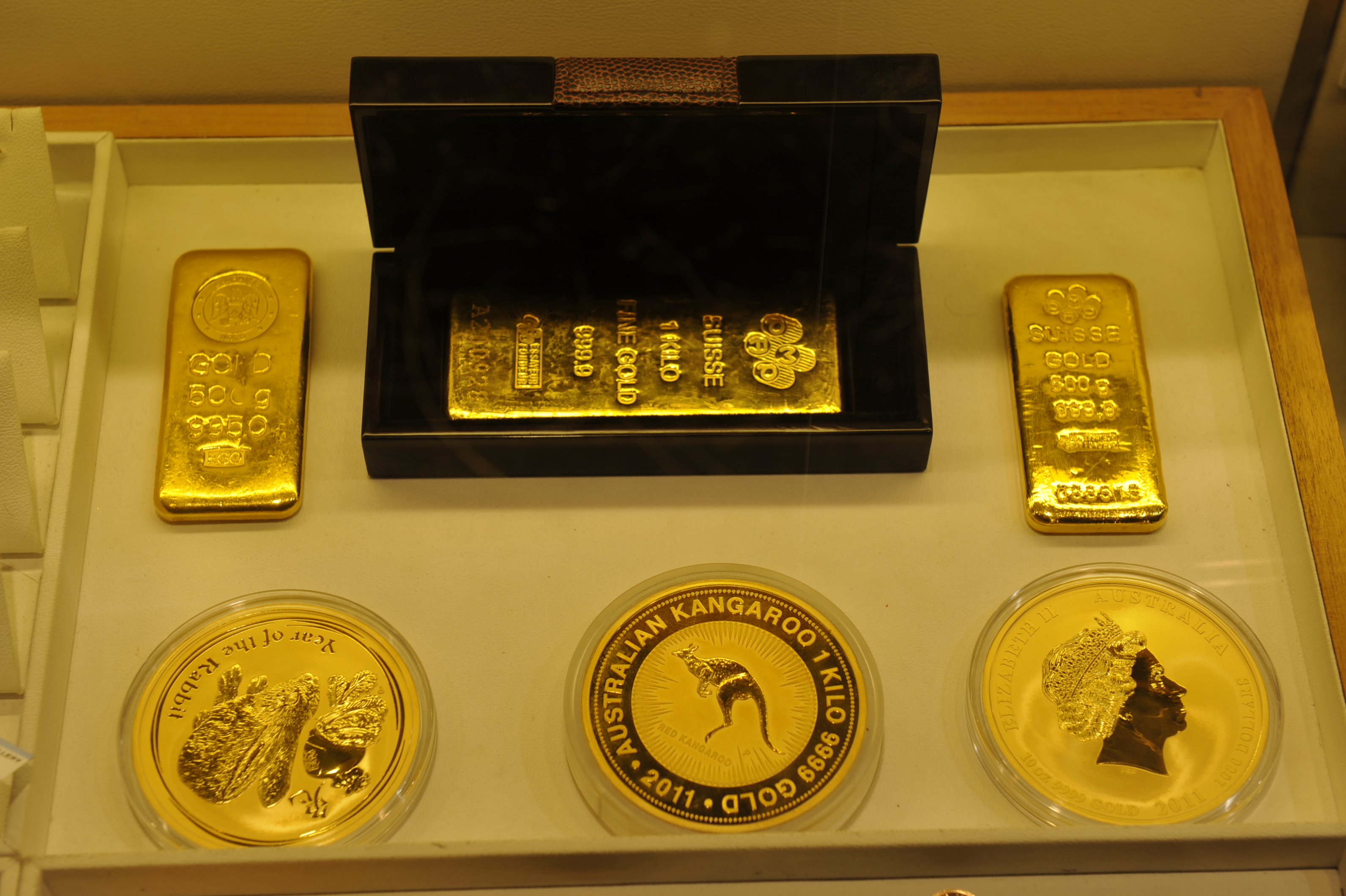 Gold bars or coins in a secure vault.