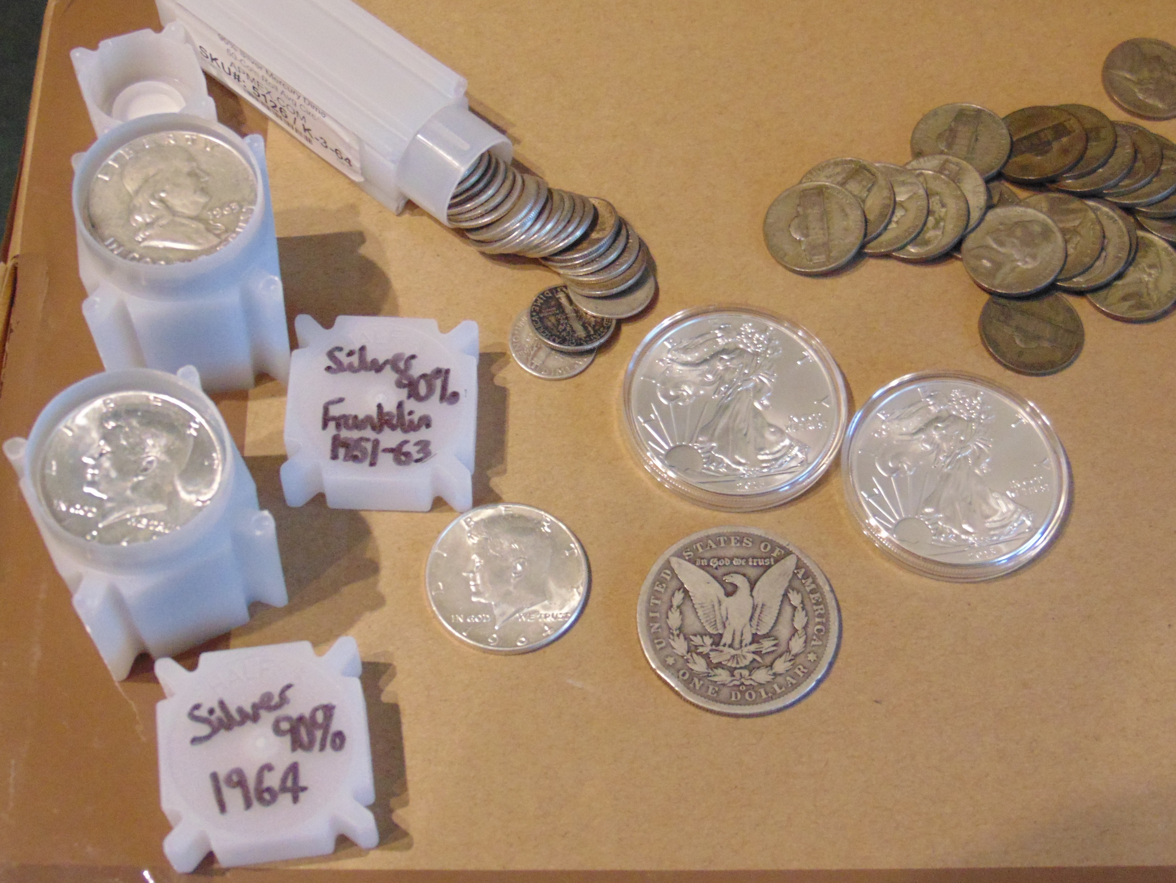 Silver bullion bars and coins in their original packaging