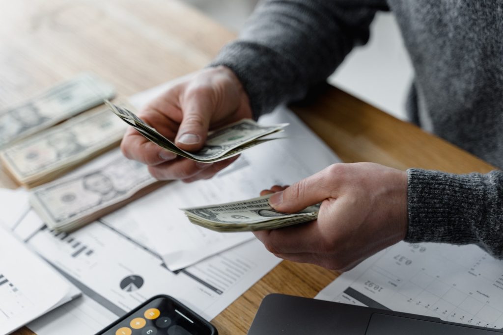 Close-Up Shot of a Person Holding Paper Money